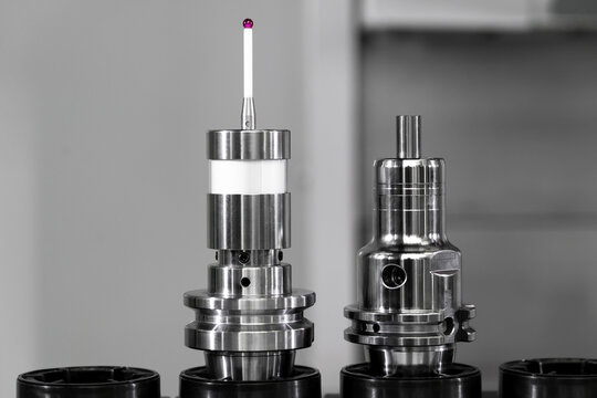 Two precision engineering components are showcased on a workbench, highlighting their detailed designs and functionality