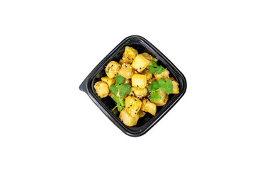 Spiced potato cubes are topped with cilantro and ready for serving in a sleek black container