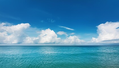 Obraz premium the sky is clear for a summer getaway concept at the ocean with summer sea water surrounded by beautiful clouds