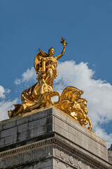 Obraz premium New York, NY, USA - August 2, 2023: Maine monument golden statue closeup on SW corner Central Park under blue cloudscape