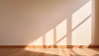 warm sunlight filters through a window casting soft shadows on a plain beige wall and wooden floor