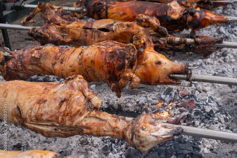 Wall mural a pig grilled traditional coal and fire.