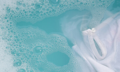 White cloth soaked in powder detergent water dissolution, washing cloth. Laundry concept