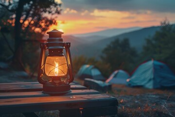 Camping acetylene lantern on wooden table in nature