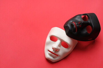 Theater arts. White and black masks on red background, above view. Space for text