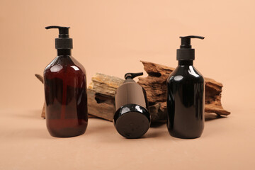 Amber and Black Pump Bottles with Eucalyptus on Beige Background for Skincare Product Mockup