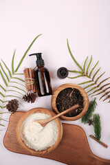 Natural Skincare Ingredients with Amber Bottle and Botanical Elements on White Background