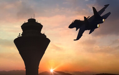 fighter jet flyby near airbase communication tower at sunrise