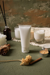 White Cosmetic Tube with Candles and Natural Decor on Rustic Background for Skincare Mockup