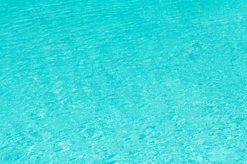 Pool side resort with pool water surface background. Sea ripples on blue pool background. Sea background. Swimming pool rippled. Summer vacation. Spa resort on summer vacation. Beachfront