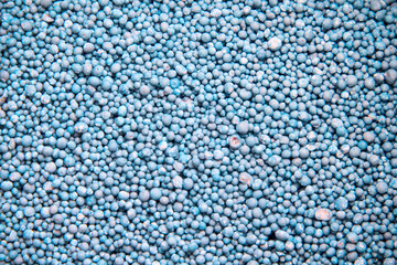 Mineral fertilizer blue texture closeup  for plants or tree top view background