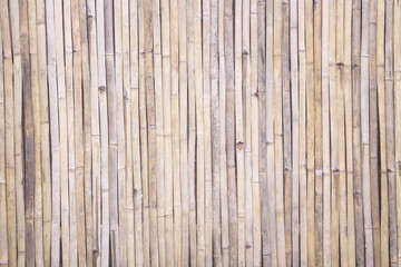 Bamboo wood wall fence light brown rustic on background with vertical seamless patterns