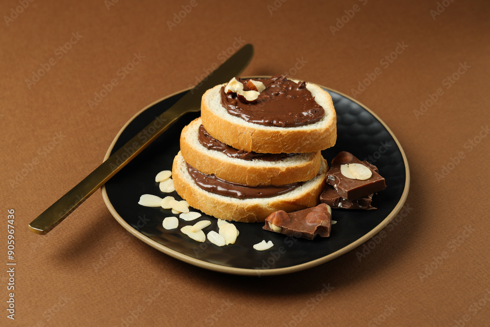 Sticker bread with chocolate paste in a bowl on a brown background