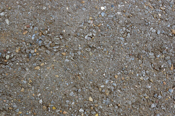 Rough asphalt surface with crushed stone