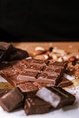 Chocolate chip cookies, dark and white chocolate bar, small bowl of oatmeal and nuts. International Chocolate Day.