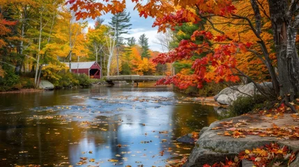 Fototapete A beautiful autumn scene in New England with colorful fall foliage, a historic covered bridge, and a serene river © Sasa Visual