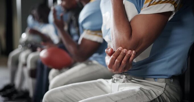 Man, elbow and football player with injury in locker room from game, match or accident. Closeup of male person or athlete with sore joint, muscle or bruise from intense sport, mistake or foul play