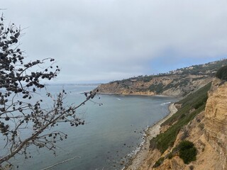California Beach with Rocky Hills and Trees with Cloudy Skys 