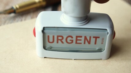 Red URGENT word stamp on a white paper 