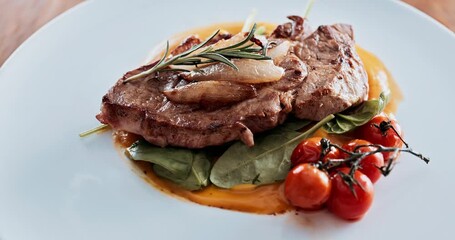 Steak, plate and meal in restaurant, ready and luxury of fine dining in hotel, hospitality and beef. Kitchen counter, menu and meat on table for show of culinary skills in food industry and cuisine