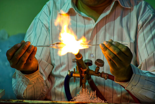 An Egyptian glassblower gives a demonstration of glassworking to tourists.