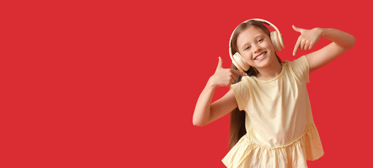 Little girl in headphones pointing at herself on red background