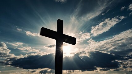 Silhouetted wooden cross on hilltop, blue sky, white clouds, sunset light, symbol of faith and hope