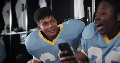 Football, players and men with cellphone, typing and social media in locker room, texting and app. People, sports and friends with smartphone, mobile user and internet with connection and message - Powered by Adobe