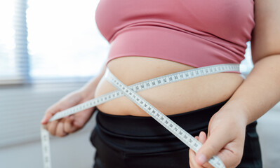 Obese Woman with fat upset about her belly. Overweight woman touching his fat belly and want to...