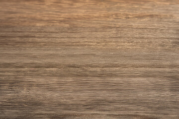 Close-up of a smooth wooden surface, showcasing rich textures and natural grain patterns ideal for backgrounds or design purposes.