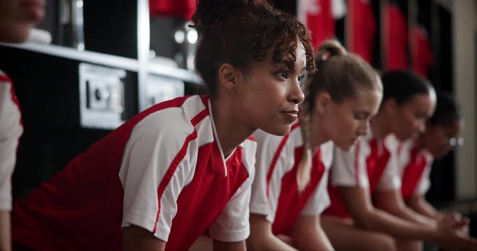 Fitness, mission and soccer player woman in locker room with teammates for competition, game or match. Breathing, concentration and sports with football team on bench together for start of tournament