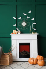 Interior of living room decorated for Halloween with fireplace and paper bats