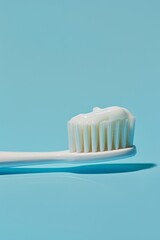 Close-up of a toothbrush with toothpaste on a pastel blue background, perfect for oral care and hygiene product promotions Generative AI