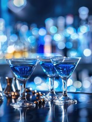 Three glasses with blue liquid