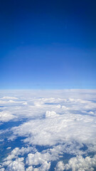 view from the plane, blue sky with clouds