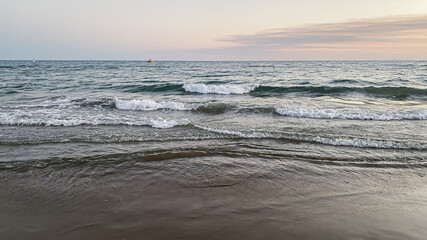 view of the seashore, the sea at sunset