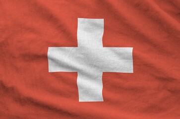 Switzerland flag depicted on folded wavy fabric of old cloth close up