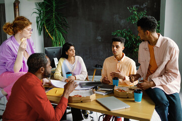 Entrepreneurs lunch break. Eating pizza. Creative office workers