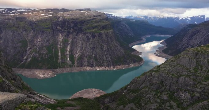 Aerial Pullback Reveals Incredible Trolltunga - Trolls Tongue Rock Cliff in Norway. Top Hiking Destination