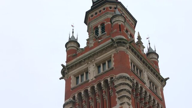 Closeup shot capturing exterior architecture of Town Hall Belfry, a UNESCO site in Dunkirk, France during daytime.