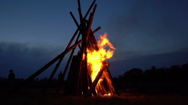 Beautiful bonfire on meadow on August 1st national holiday of Switzerland at Swiss City of Z&uuml;rich on a summer night. Movie shot August 1st, 2024, Zurich, Switzerland.