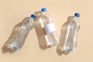 Bottles of clean water on beige background