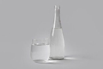 Bottle of clean water and glass on white background