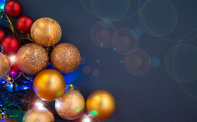 Gold and red Christmas baubles. baubles lie on a blue background. Close-up. Space for text.
