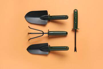 Set of gardening tools on orange background