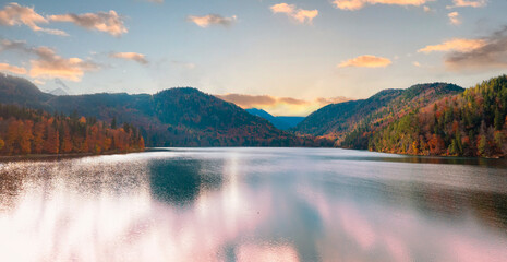Panoramic view  of sunset scene with the Alpsee lake in Autumn trees season and Bavaria Alps in...