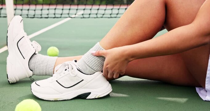 Tennis, player and woman with ankle injury on court with accident, muscle strain and sprain during game. Sport, shoes and athlete in tournament match with foot pain, inflammation or bone tension