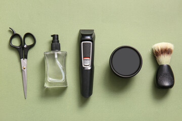 Set of male shaving accessories on green background