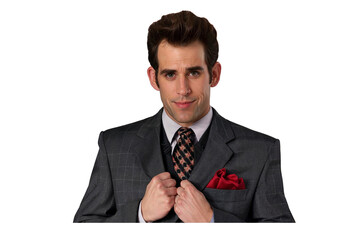 A confident man with shoulder-length brown hair wearing a grey suit and patterned tie, adjusting his jacket