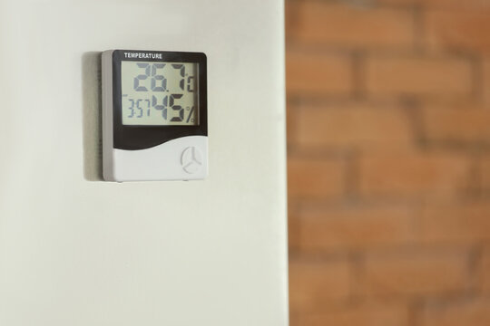Digital hygrometer on wall in kitchen, closeup